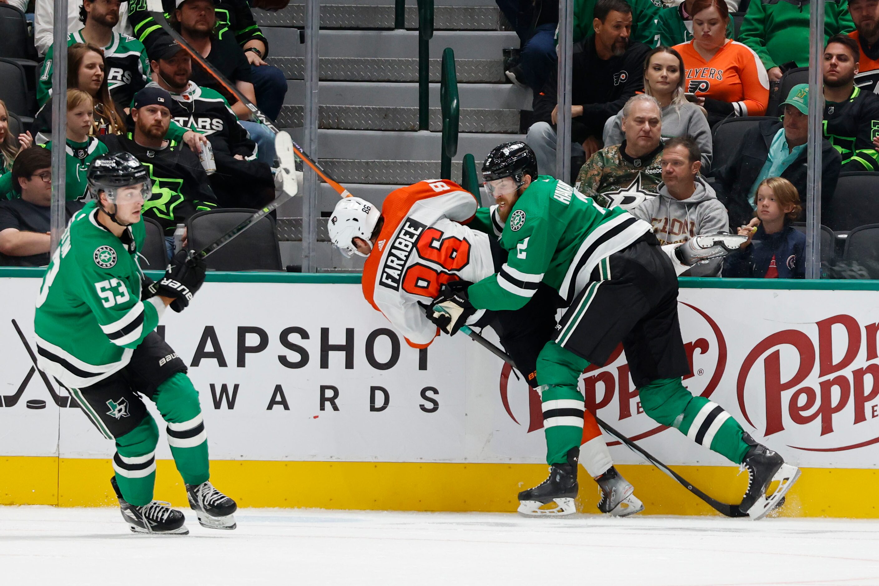 Dallas Stars defenseman Jani Hakanpaa (right) upends Philadelphia Flyers left wing Joel...