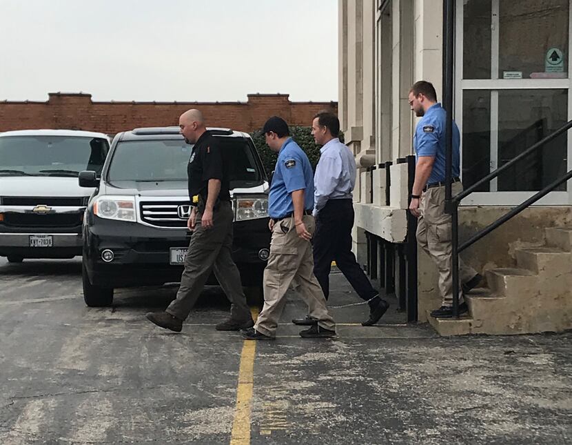 Mark Jordan, second from right, leaves the Sherman federal courthouse after being found...