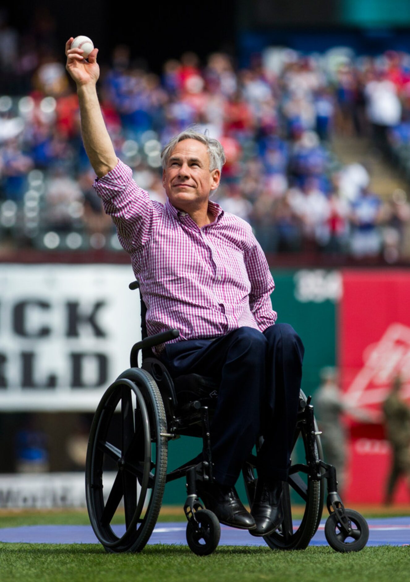 Texas Governor Greg Abbott throws the first pitch before an opening day MLB game between the...