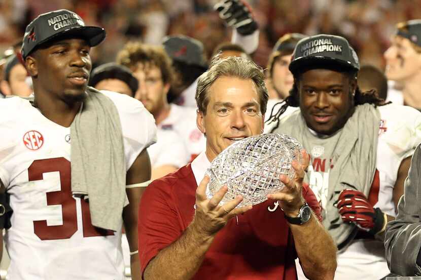 Alabama coach Nick Saban holds the Coaches Trophy after the 2013 BCS championship against...
