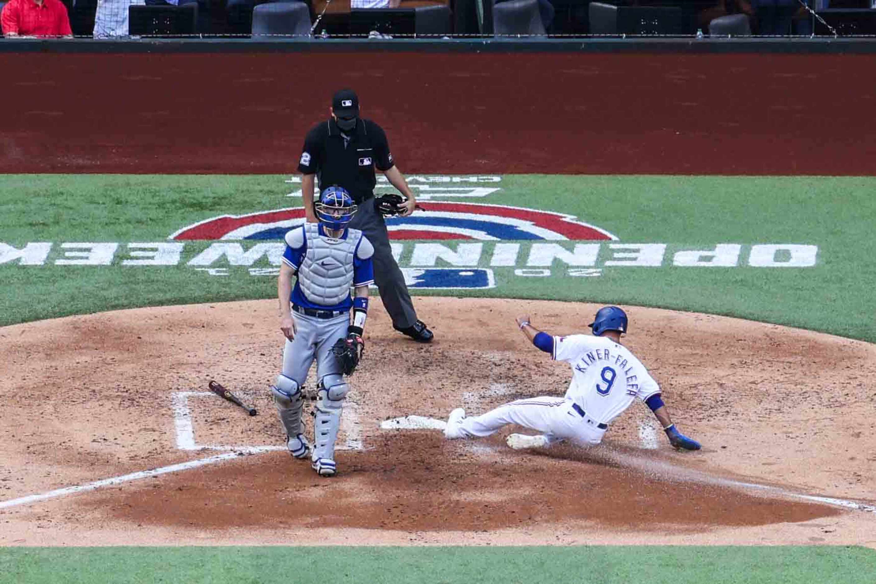 Texas Rangers' infielder Isiah Kiner-Falefa No. 9 slides to home plate to add the first run...