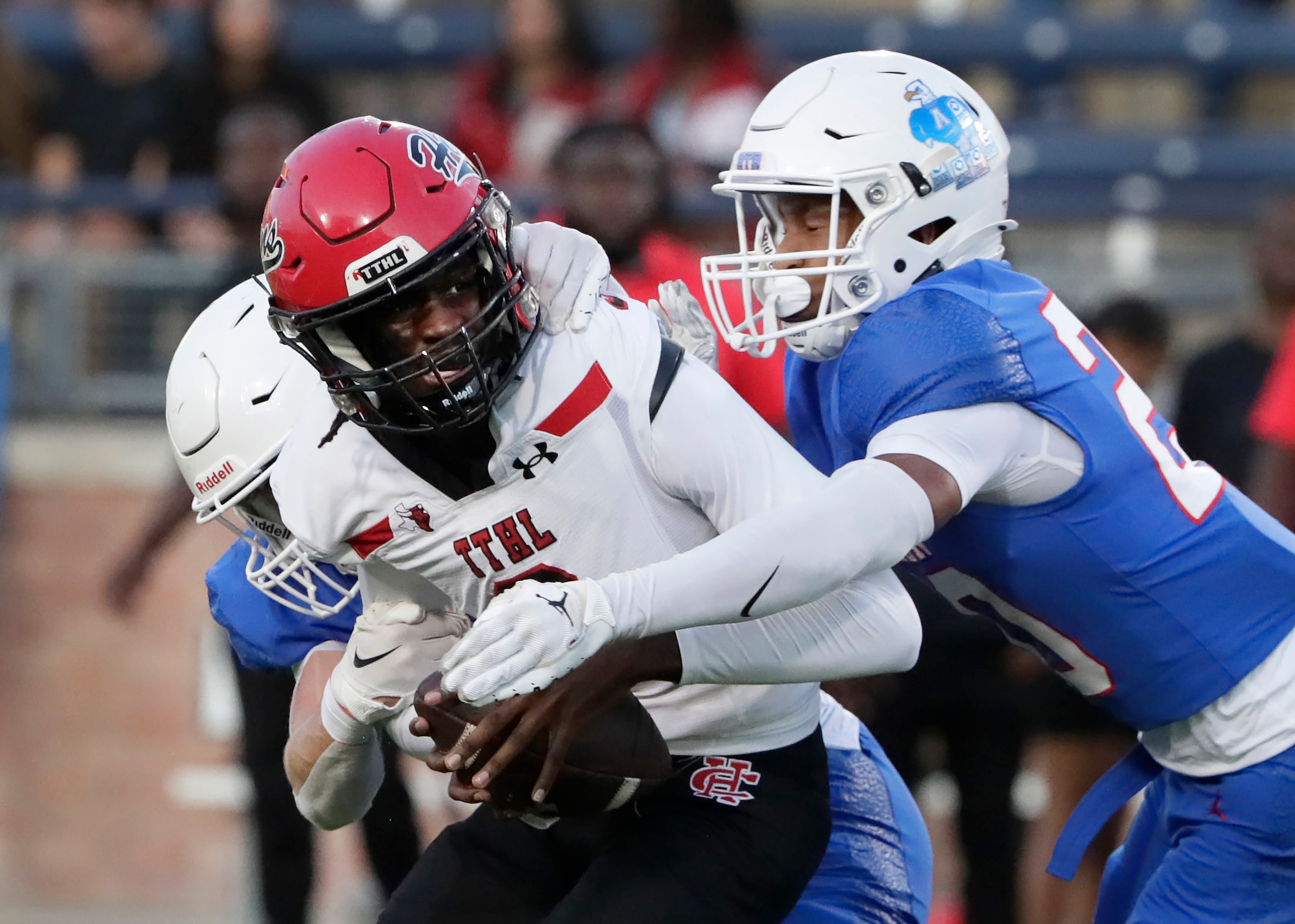 Cedar Hill High School quarterback Tamarion Crochett (3)  is sacked by Allen High School...