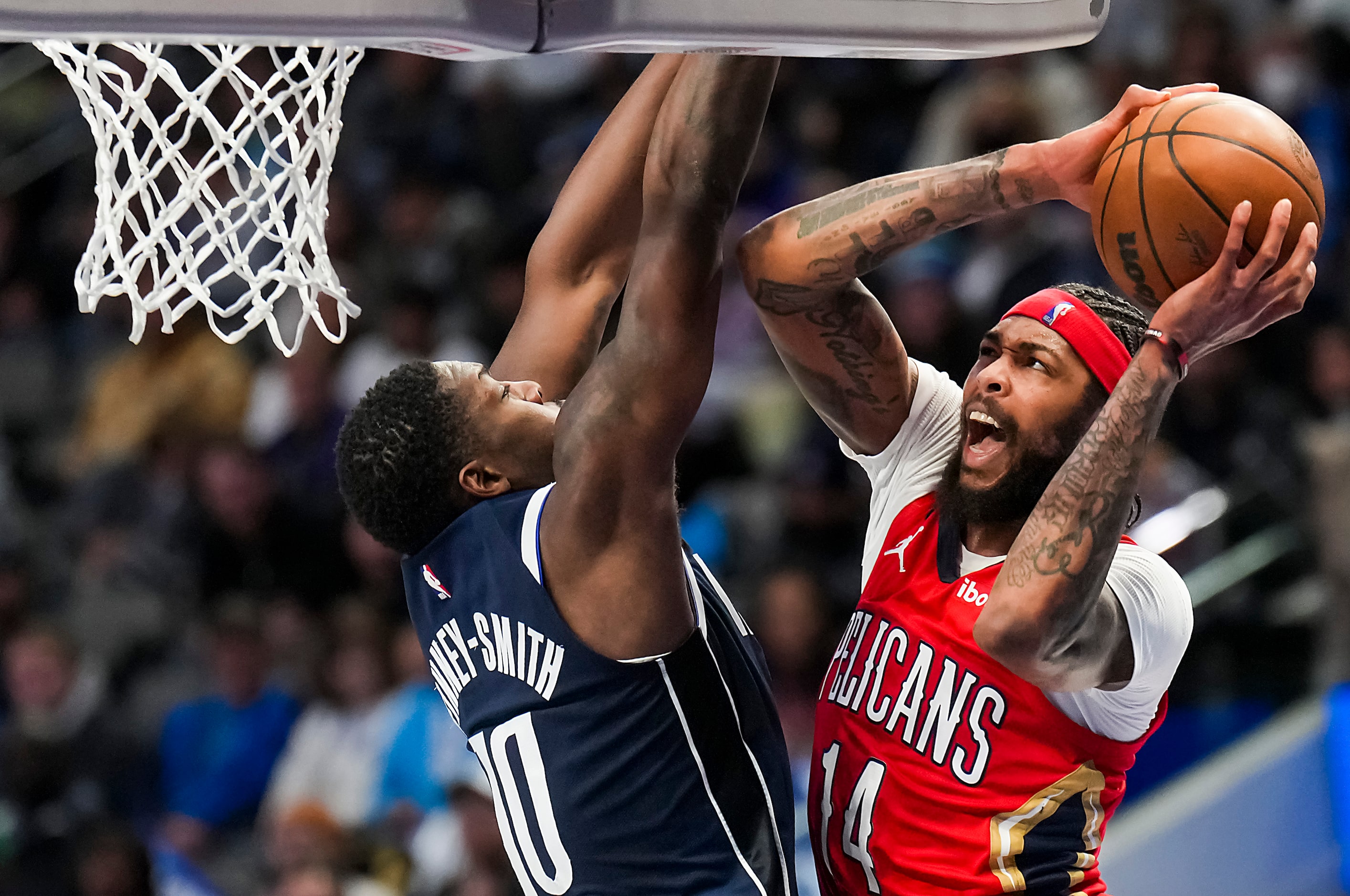 New Orleans Pelicans forward Brandon Ingram (14) drives to the hoop against Dallas Mavericks...