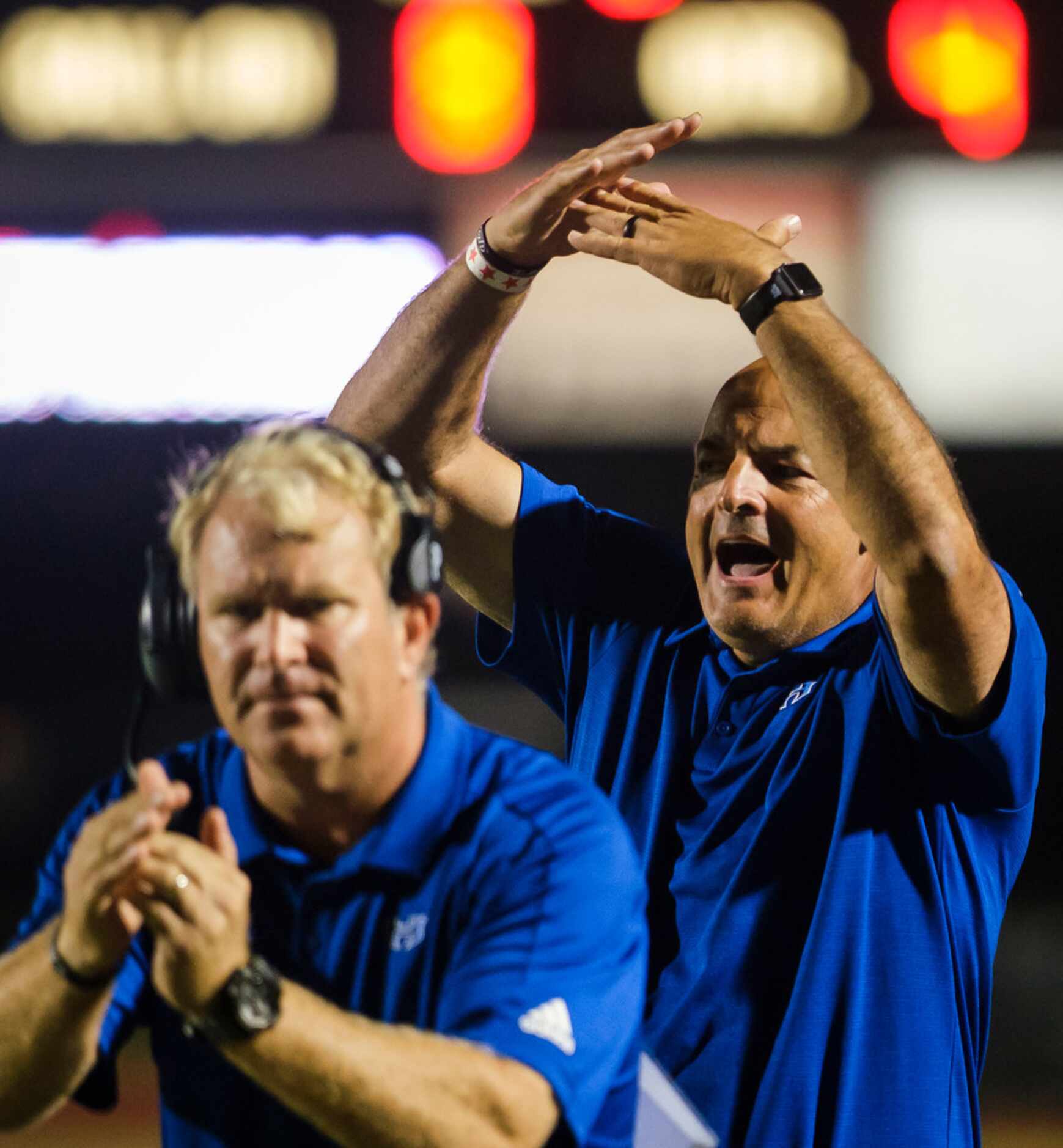 Hebron head coach Brian Brazil (right) calls for a timeout during the second half of a high...