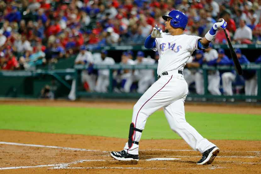 Texas Rangers left fielder Carlos Gomez (14) connects on a three-run homer in the third...