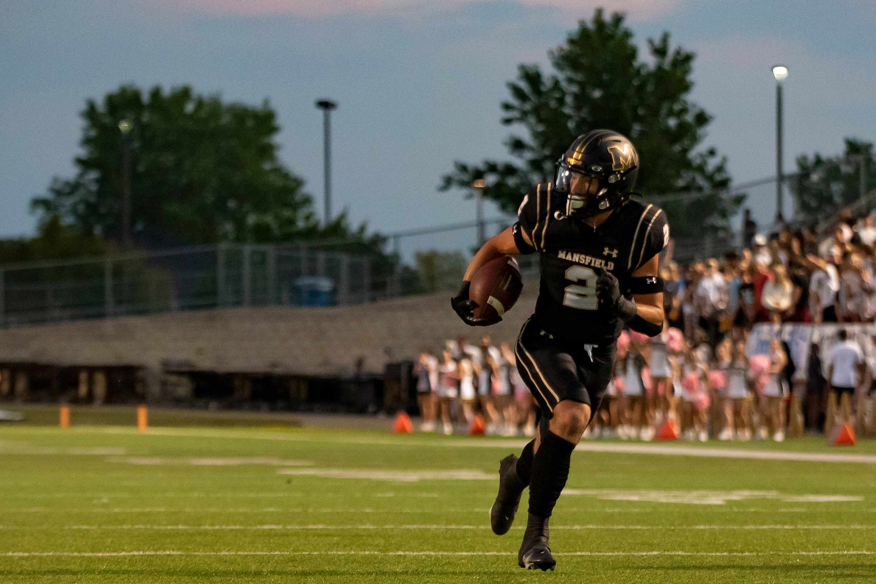 Mansfield senior Hayden George (2) runs up the field to score a touchdown during a District...