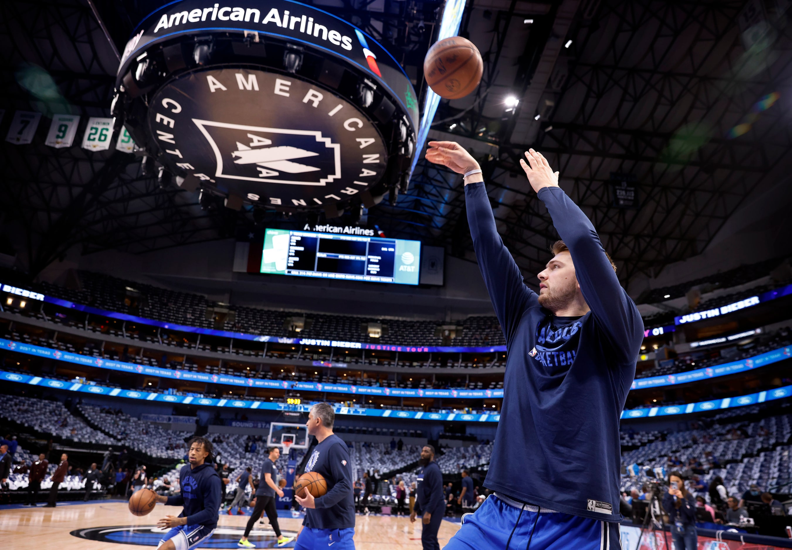 Dallas Mavericks guard Luka Doncic takes shots on his injured calf during warms up before...