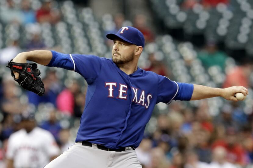 Texas Rangers' Matt Harrison delivers a pitch against the Houston Astros in the first inning...