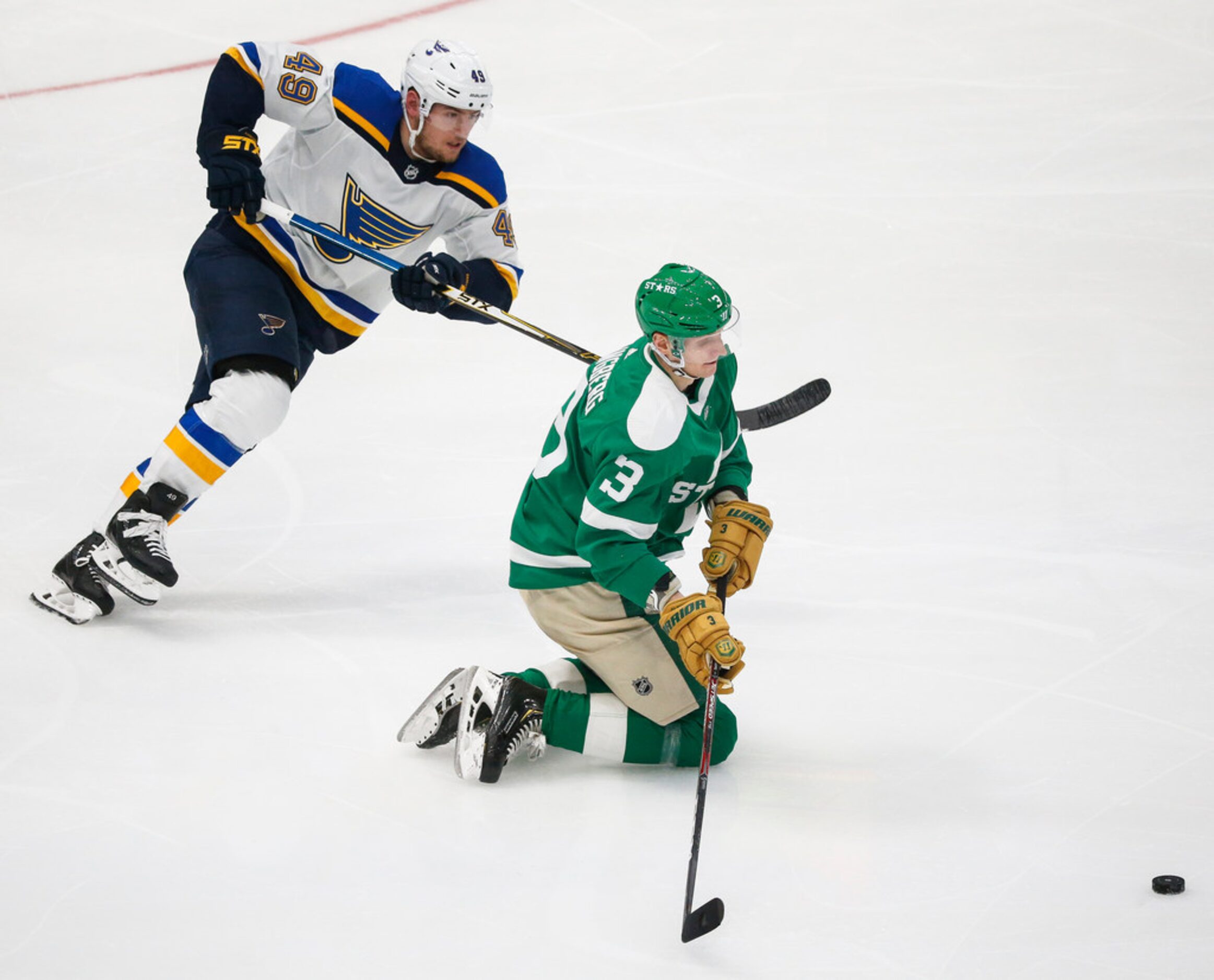 Dallas Stars defenseman John Klingberg (3) gets a slap on the puck from his knees past St....