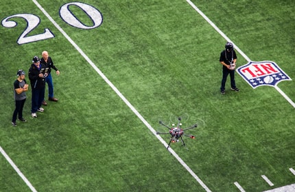 Javier Gutierrez (from left), Richard Cox, Ron Wingo and Taylor Ellis fly a drone around...