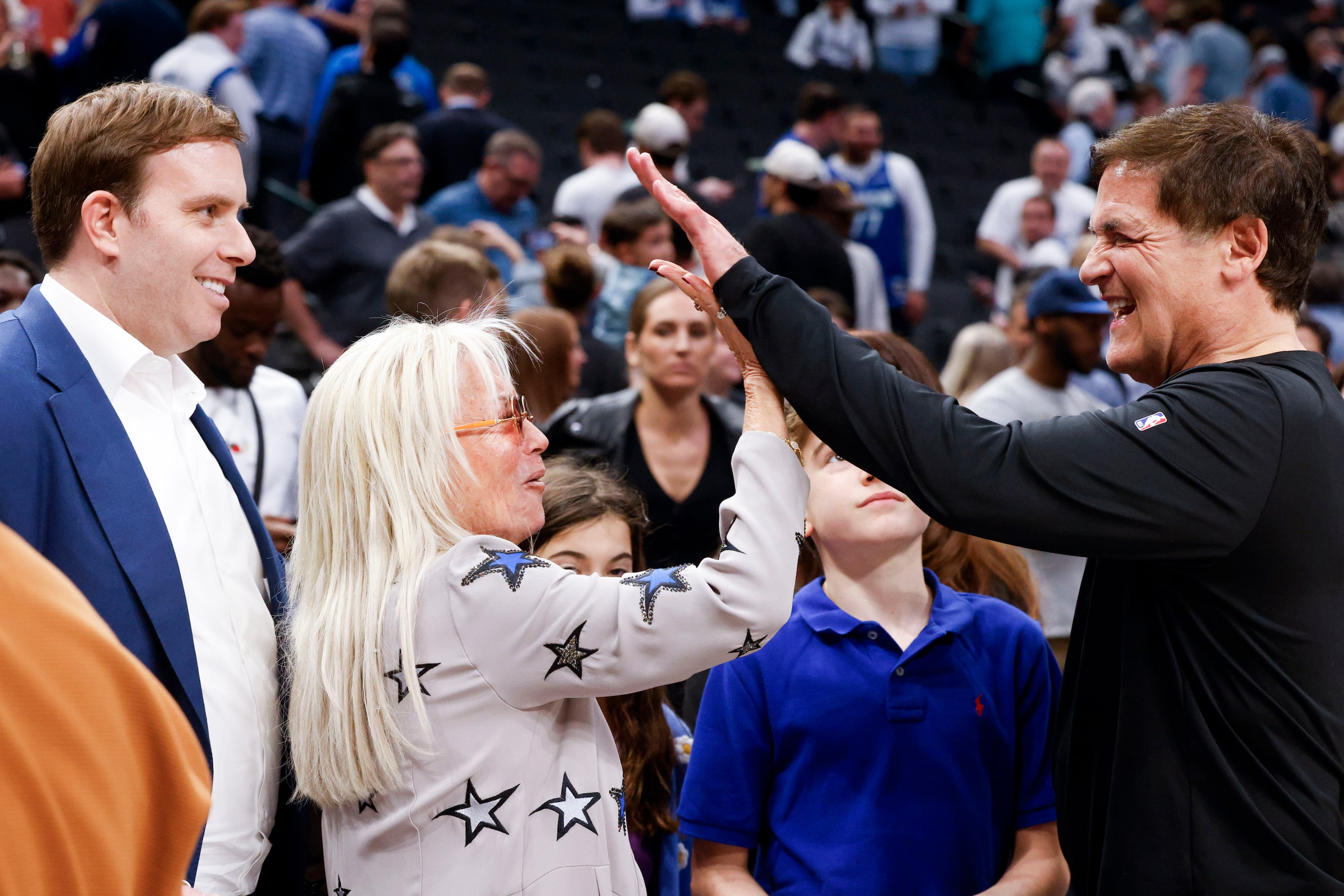 Dallas Mavericks Governor Patrick Dumont (left), watches  Miriam Adelson, (center)...