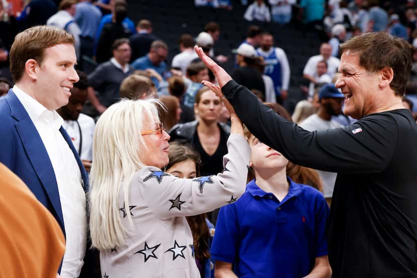 Dallas Mavericks owner Patrick Dumont watches as his mother-in-law, Miriam Adelson, also an...
