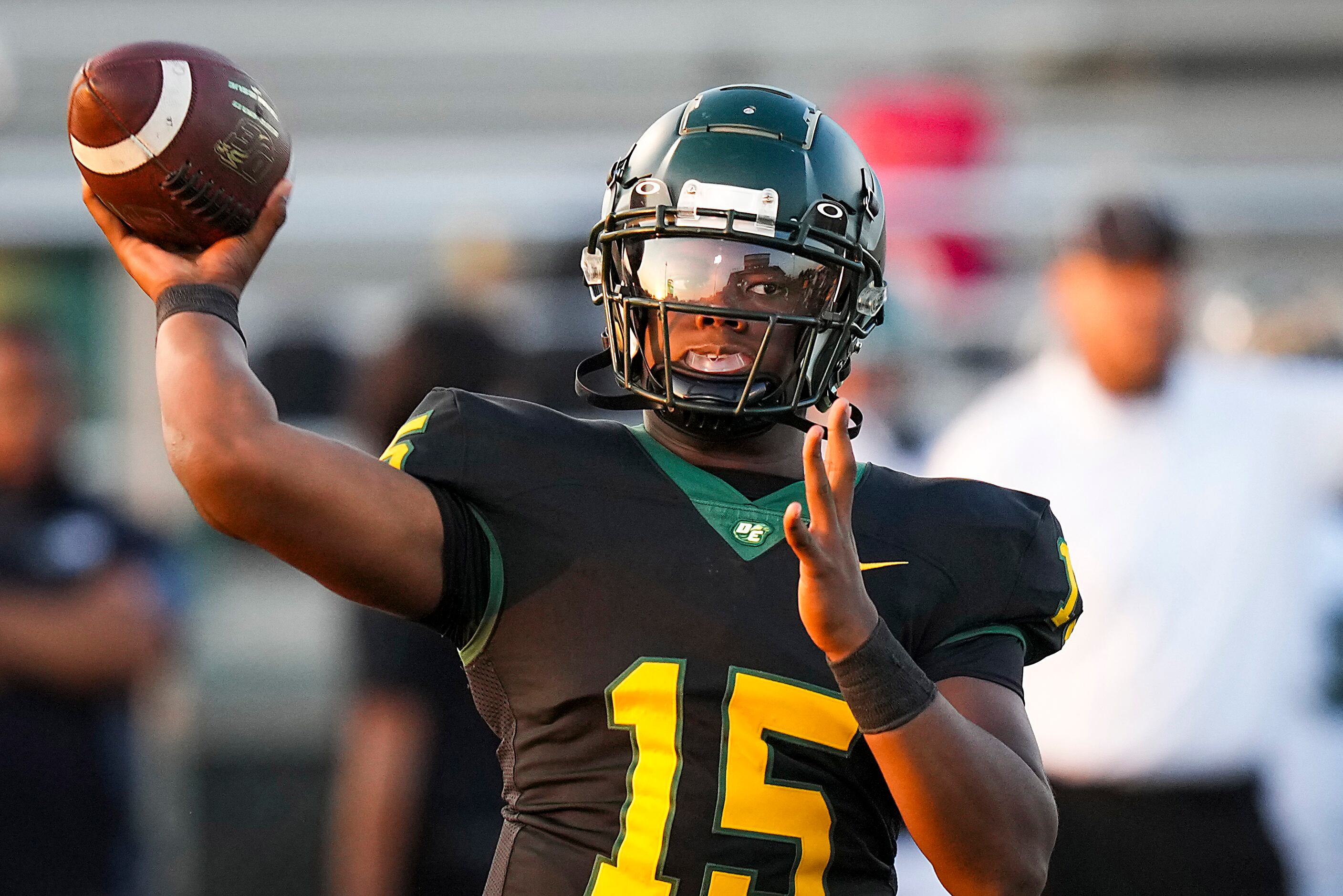 DeSoto quarterback Darius Bailey (15) throws a pass during the first half of a high school...