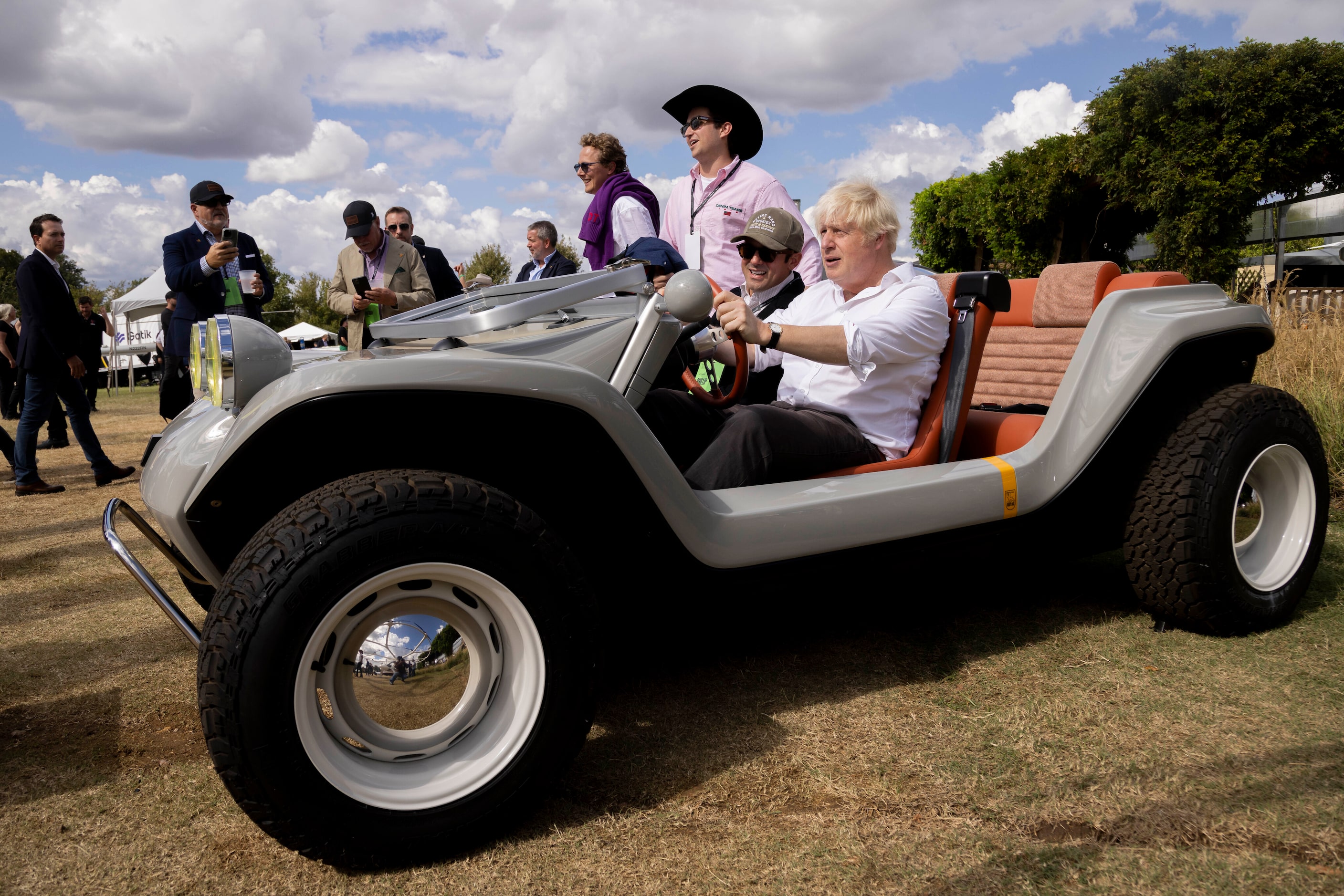 (From left in car) Phillip Sarofim, chairman of Meyers Manx, and former British Prime...