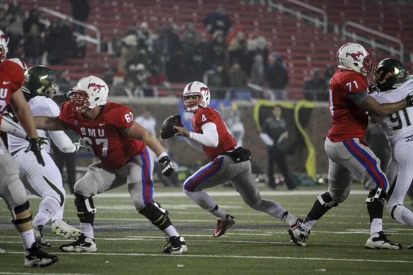 SMU's offensive line works to protect SMU quarterback Matt Davis. Andy Jacobsohn/Staff...