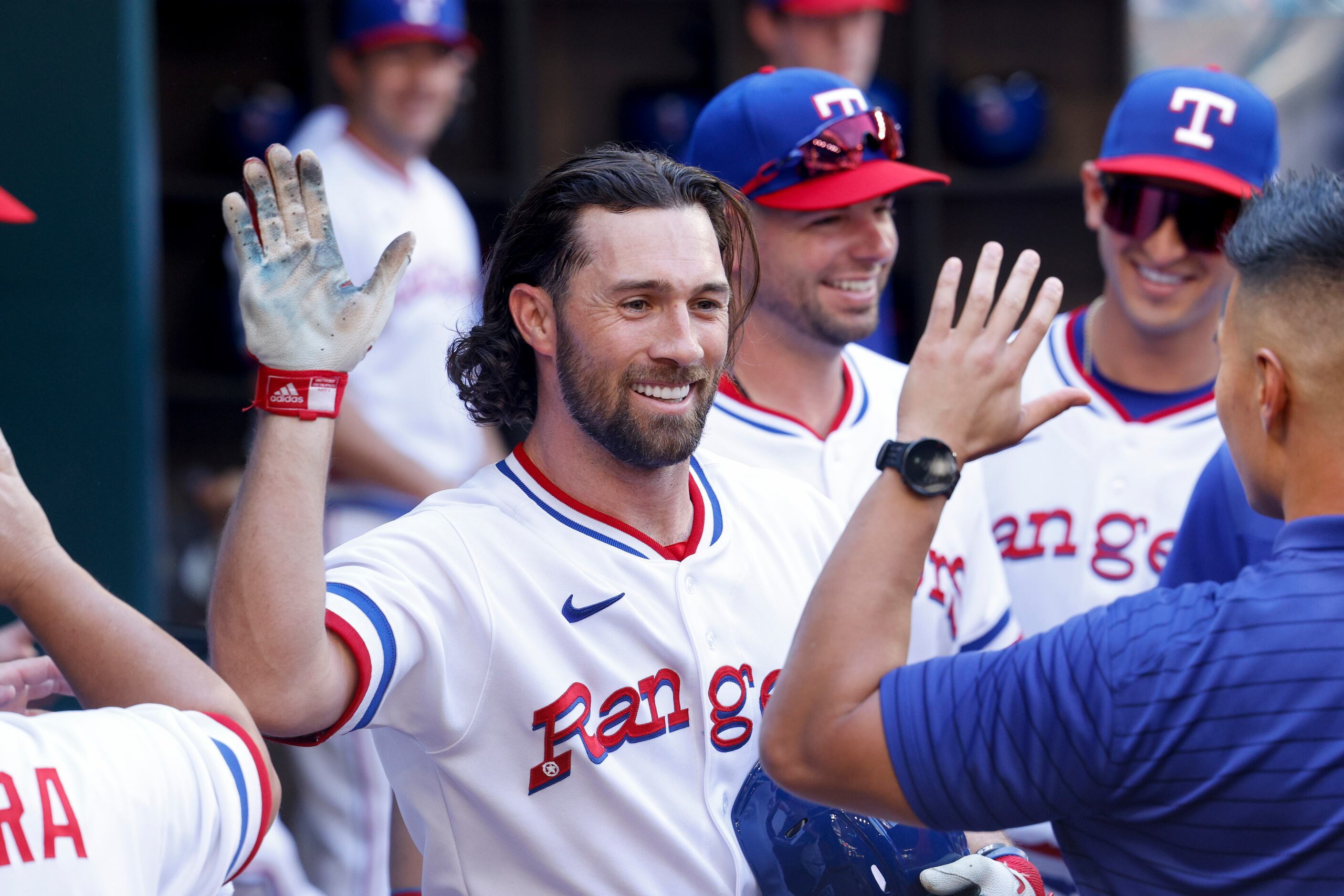 Texas Rangers left fielder Charlie Culberson (11) celebrates a home run in the dugout during...