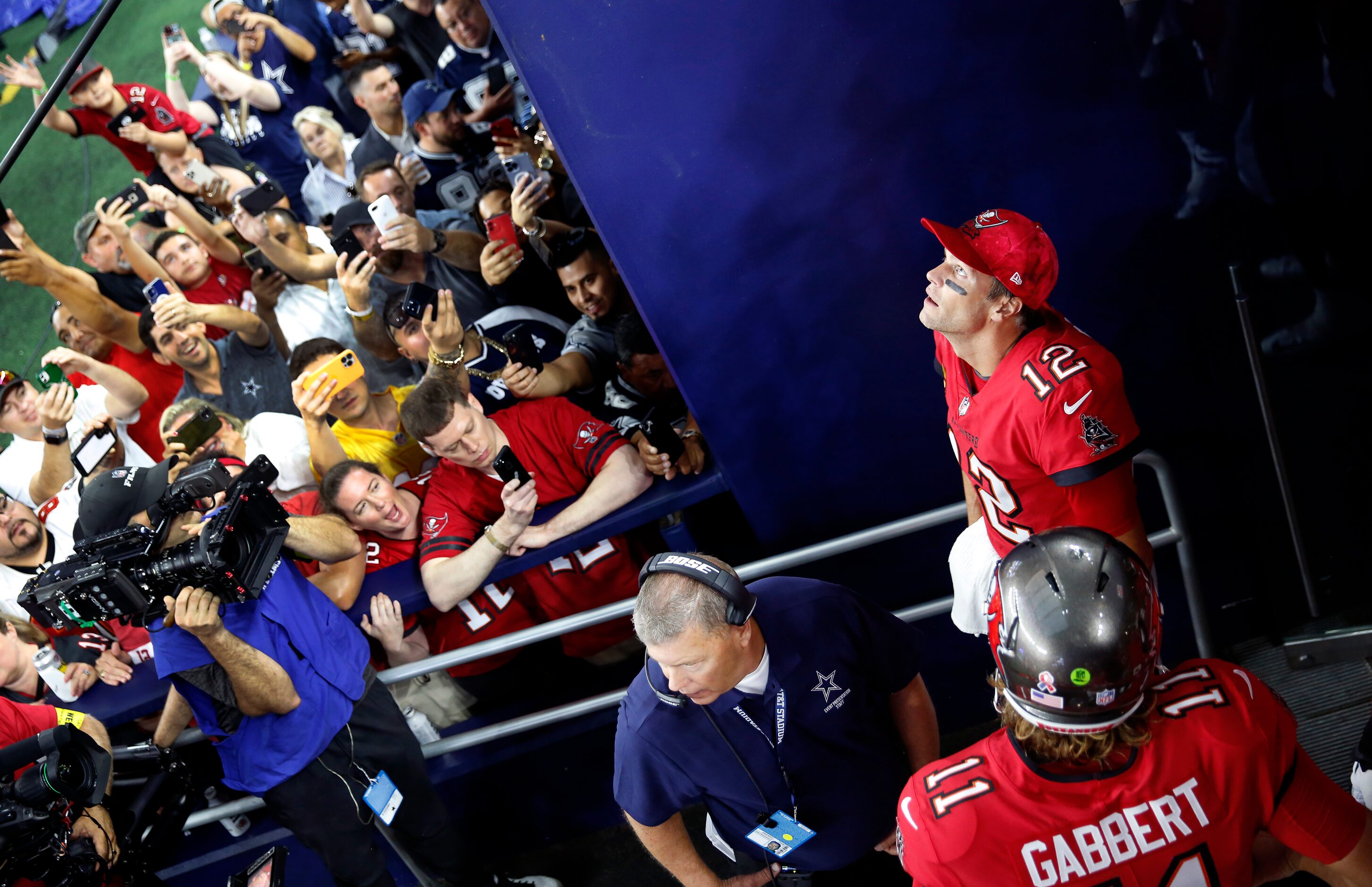 Tampa Bay Buccaneers quarterback Tom Brady (12) watches the video board as fans clamor to...