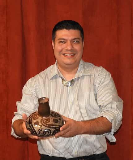 Chase Kahwinhut Earles, holding a pot he created through traditional Caddo methods.