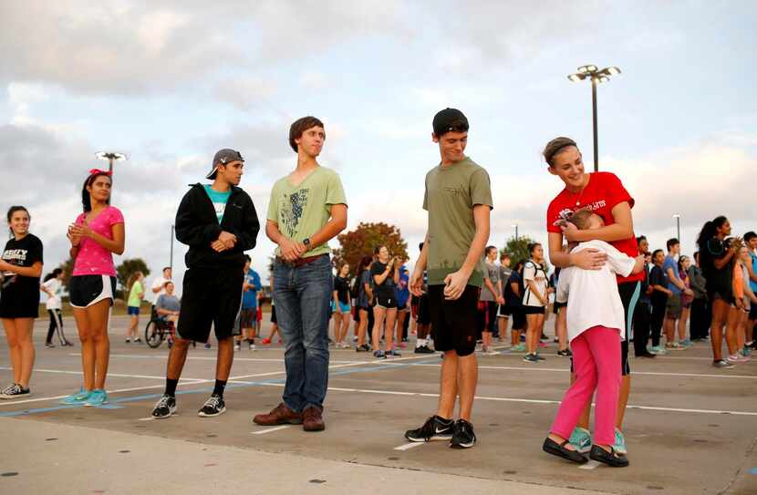 
Emme Benton, 5, gets a hug from Jenna Heflin as the Frisco Liberty Marching Band practices...