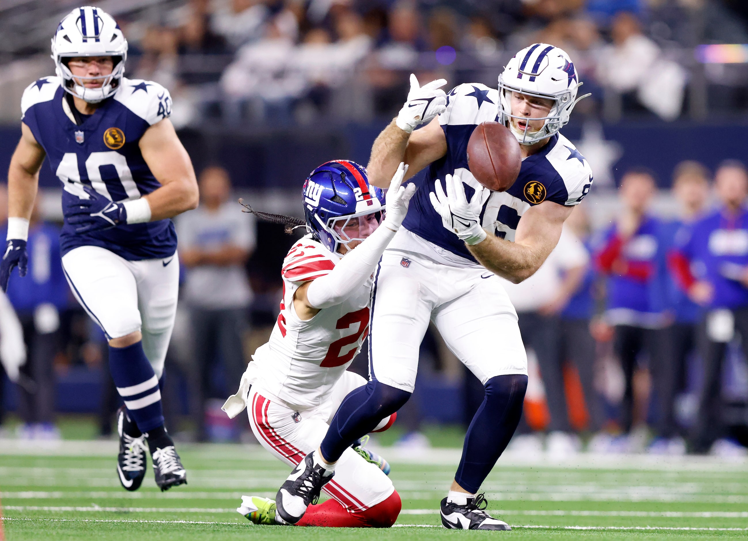 Dallas Cowboys tight end Luke Schoonmaker (86) bobbles a first half pass before securing it...