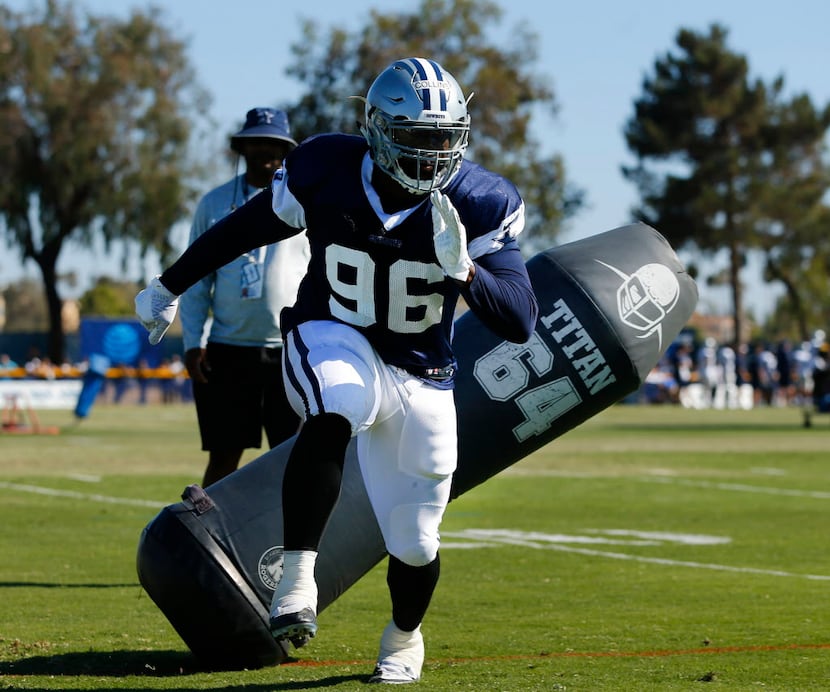 Dallas Cowboys defensive tackle Maliek Collins (96) cuts past a blocking dummy during...