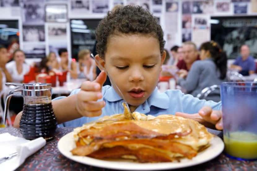Brian Armes, 5, got ready to dig into a stack of pancakes at Big State Fountain Grill on...