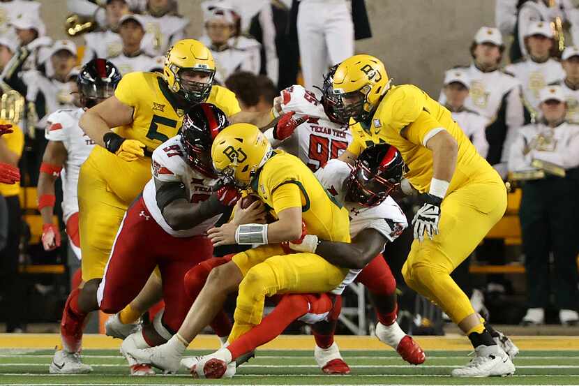 Baylor quarterback Blake Shapen, center left, is sacked by Texas Tech defensive lineman Tony...