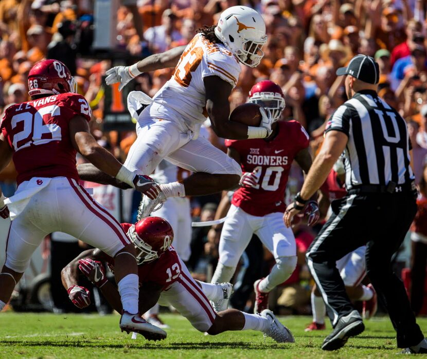 Texas Longhorns running back D'Onta Foreman (33) jumps over Oklahoma Sooners safety Ahmad...