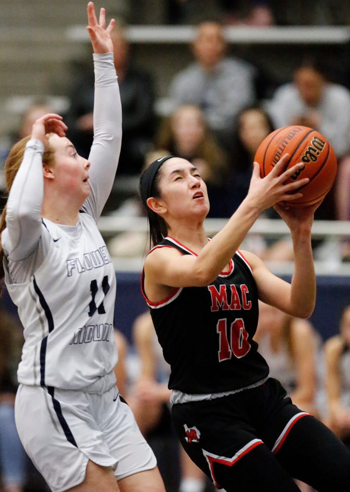 Irving MacArthur High School guard Savannah Gutierrez (10) attempts a layup as Flower Mound...