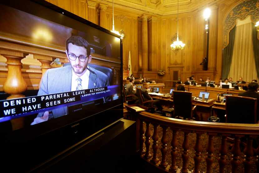 Scott Wiener, left, is shown on a monitor speaking during a San Francisco Board of...