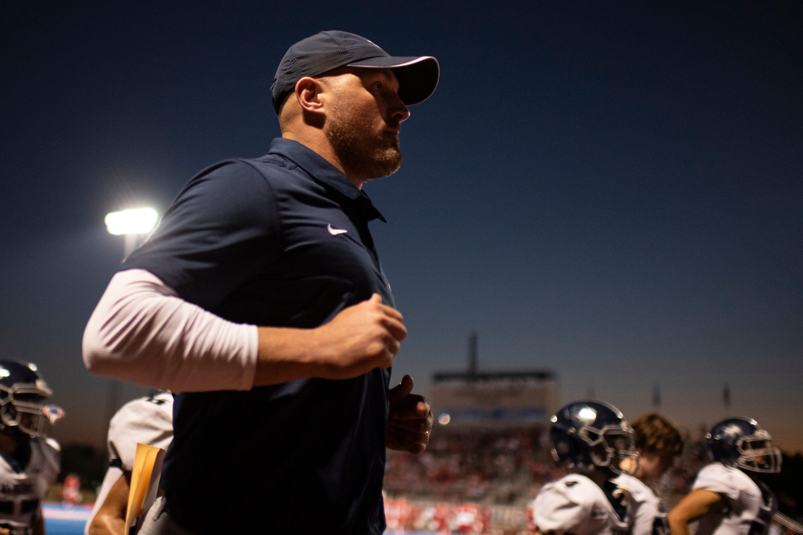 Argyle Liberty Christian Head Coach Jason Witten jogs back with his players to the locker...