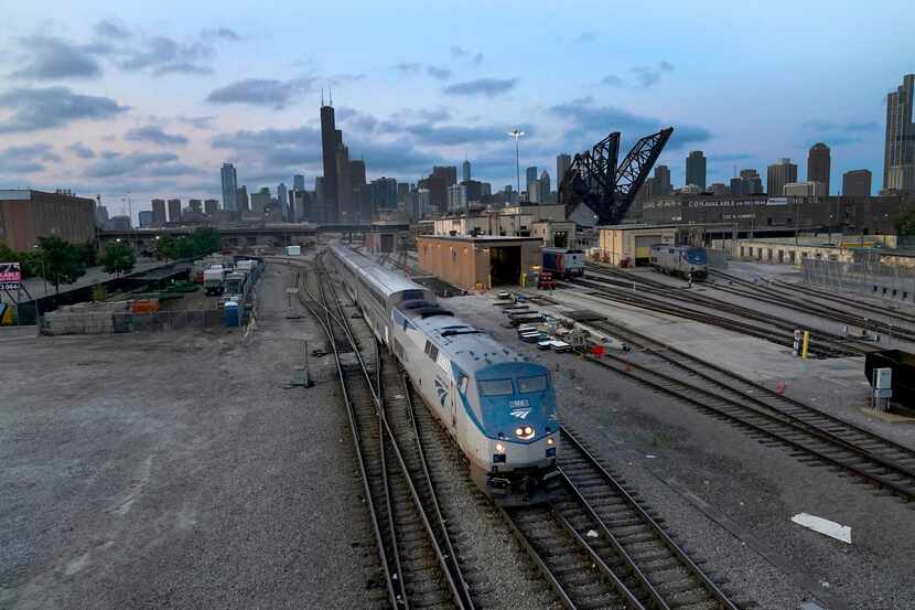 FILE - An Amtrak passenger train departs Chicago in the early evening headed south...