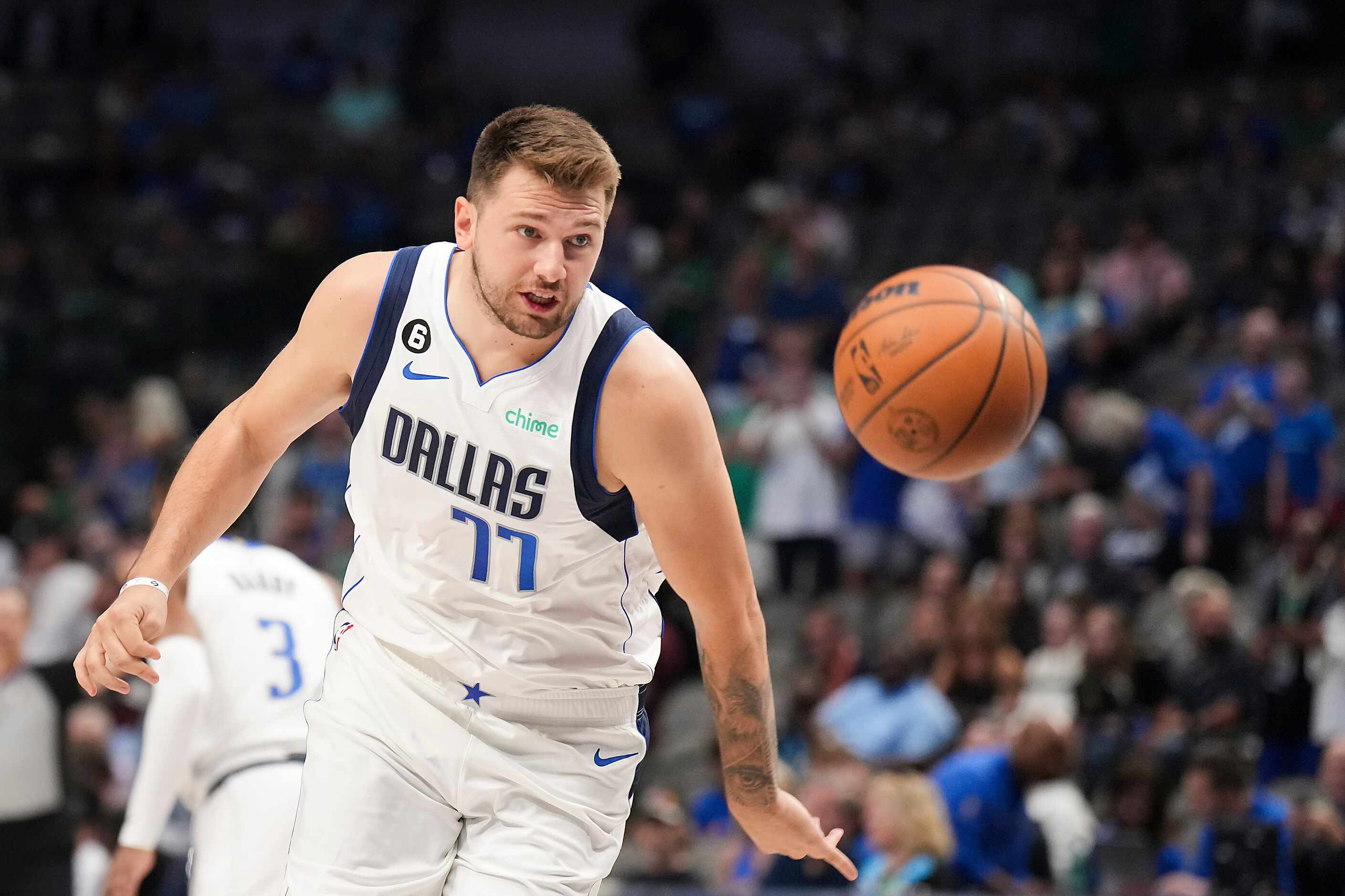 Dallas Mavericks guard Luka Doncic chases a loose ball during the first half of an NBA...