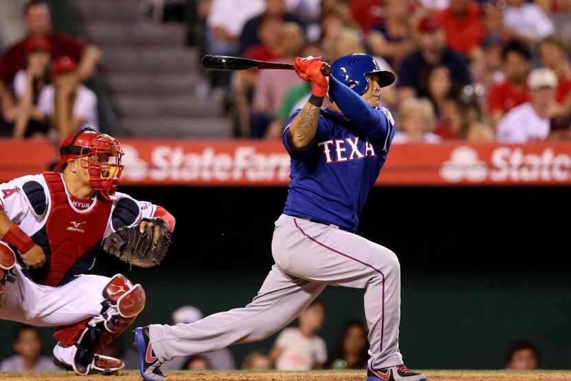 ANAHEIM, CA - MAY 02: Shin-Soo Choo #17 of the Texas Rangers hits an RBI single in the...