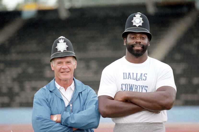 Dallas Cowboy's coach Tom Landry (left) and Cowboy's player Ed "Too Tall" Jones, smile as...