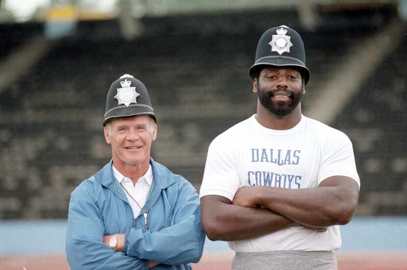 Dallas Cowboy's coach Tom Landry (left) and Cowboy's player Ed "Too Tall" Jones, smile as...