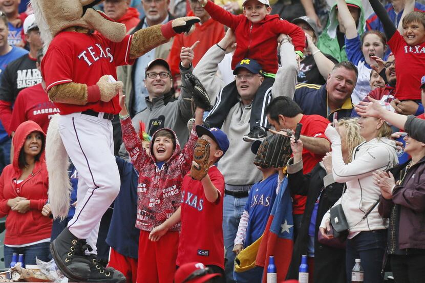 Rangers Captain interacts with the fans during the seventh-inning stretch during the Seattle...