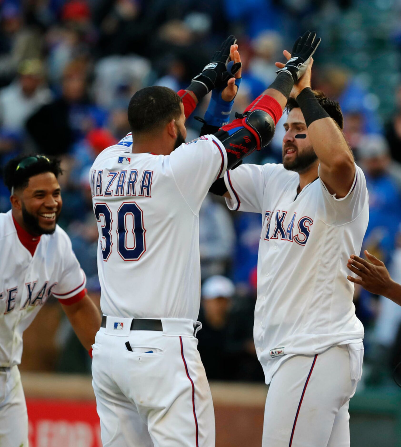 Texas Rangers Joey Gallo, right, is congratulated by teammate Nomar Mazara (30) after...