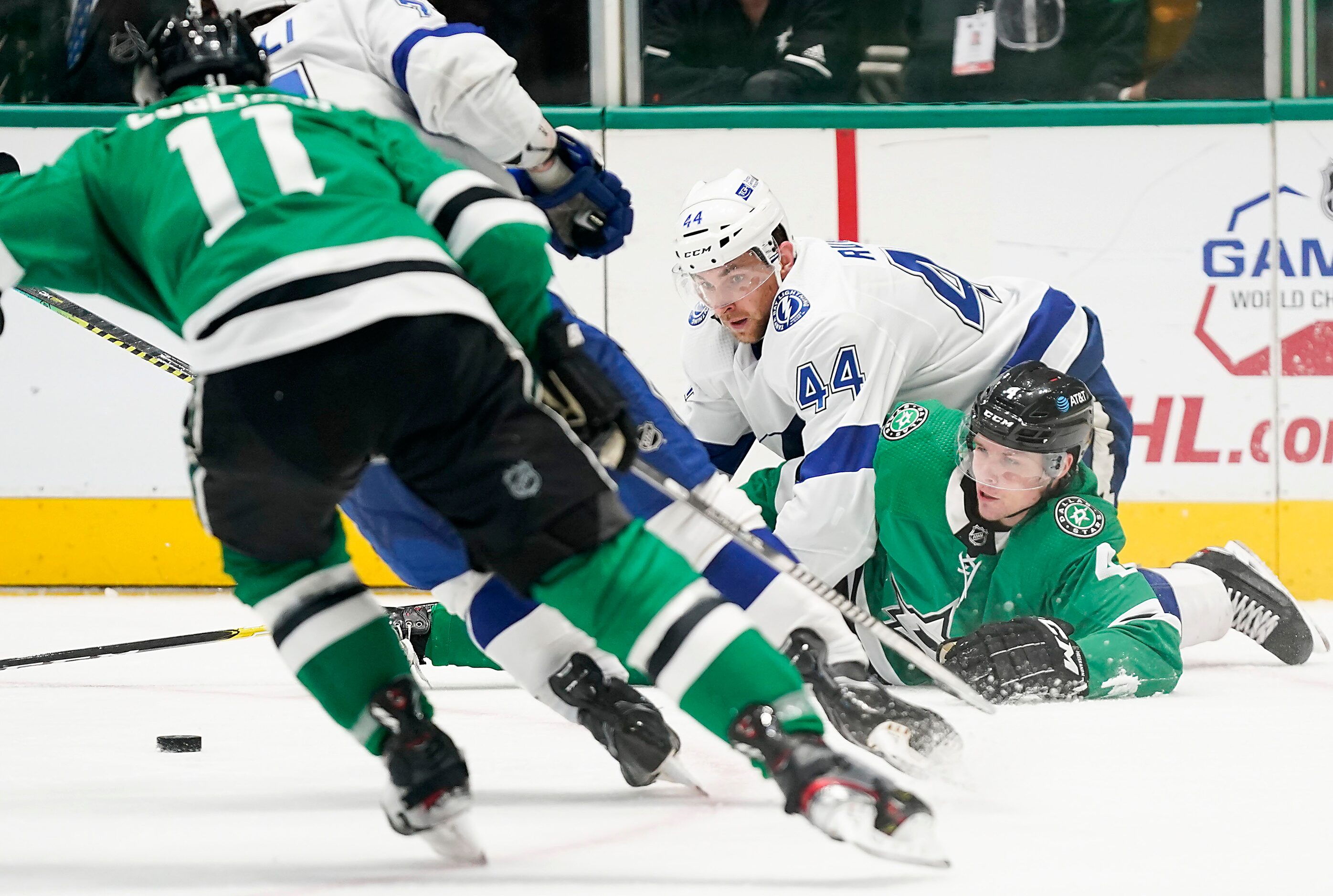 Dallas Stars defenseman Miro Heiskanen (4) fights for the puck with Tampa Bay Lightning...