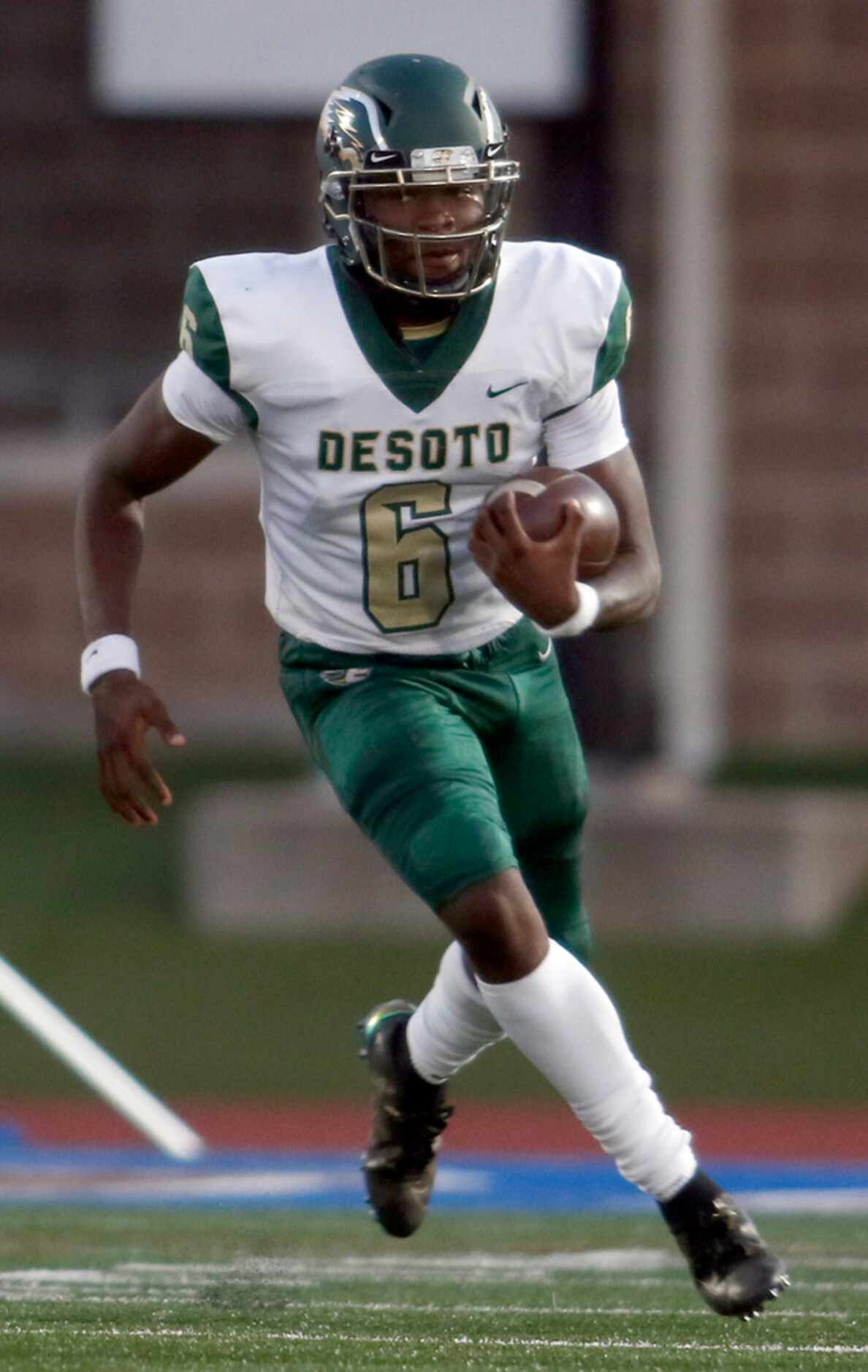 DeSoto quarterback Samari Collier (6) rolls out of the pocket for a short rushing gain...