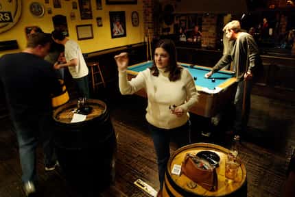 In this 2004 DMN file photo, Stephanie Doell plays a game of darts at The Londoner pub in...