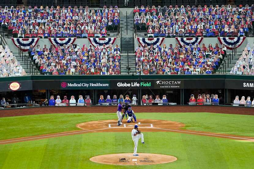 In front of a sea of cutout photos filling the empty seats, Texas Rangers pitcher Lance Lynn...
