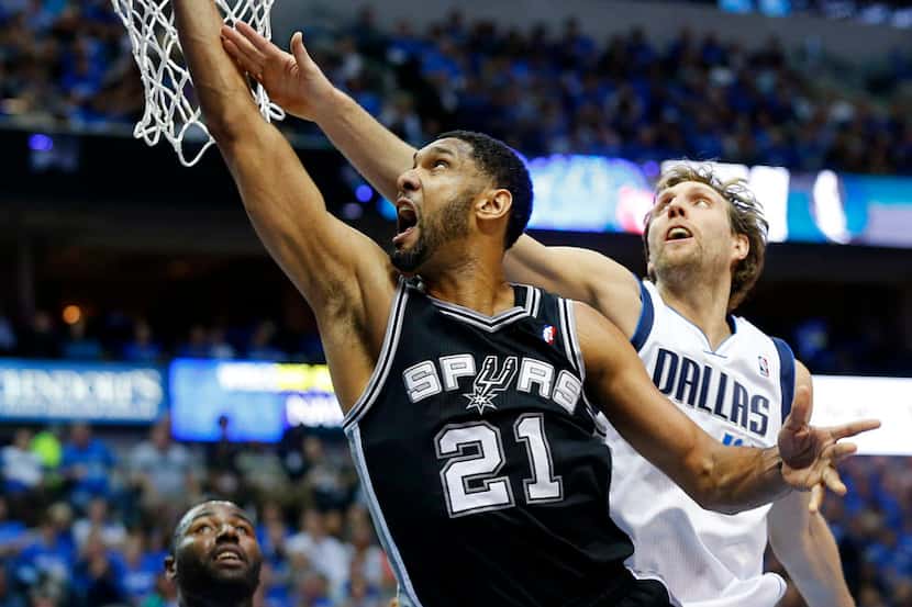San Antonio Spurs forward Tim Duncan (21) goes to the glass for a lay up as Dallas Mavericks...