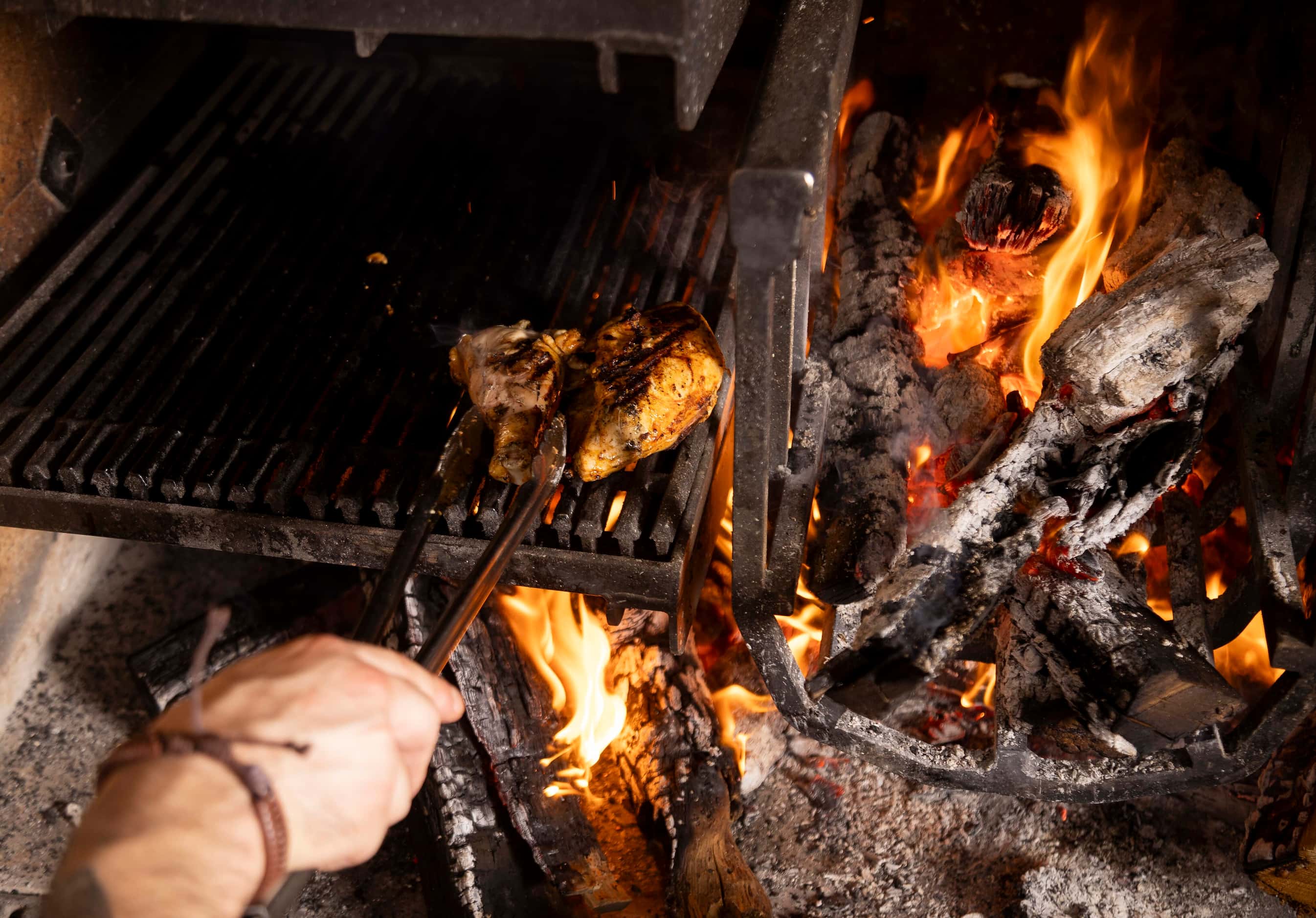 Chicken is cooked over the flames of Radici's wood-fired grill. 
