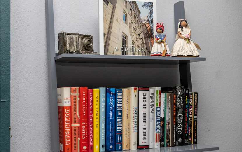 Sam Guzman's muñecas sin rostro sit on her bookshelf, next to other beloved books and...