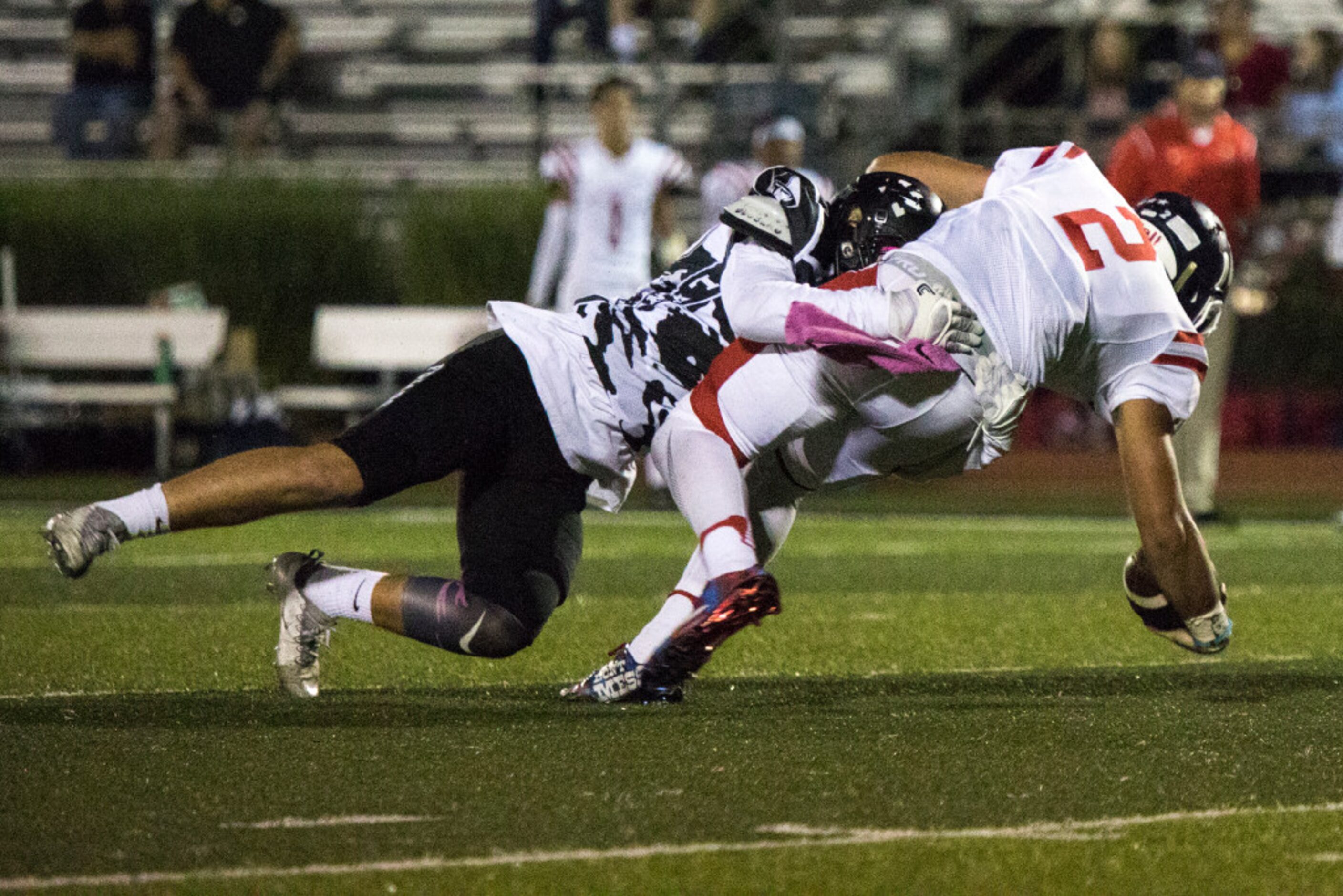 Bishop Lynch defensive lineman Chris Sigsbee (42) sacks John Paul quarterback Austin Tyler...