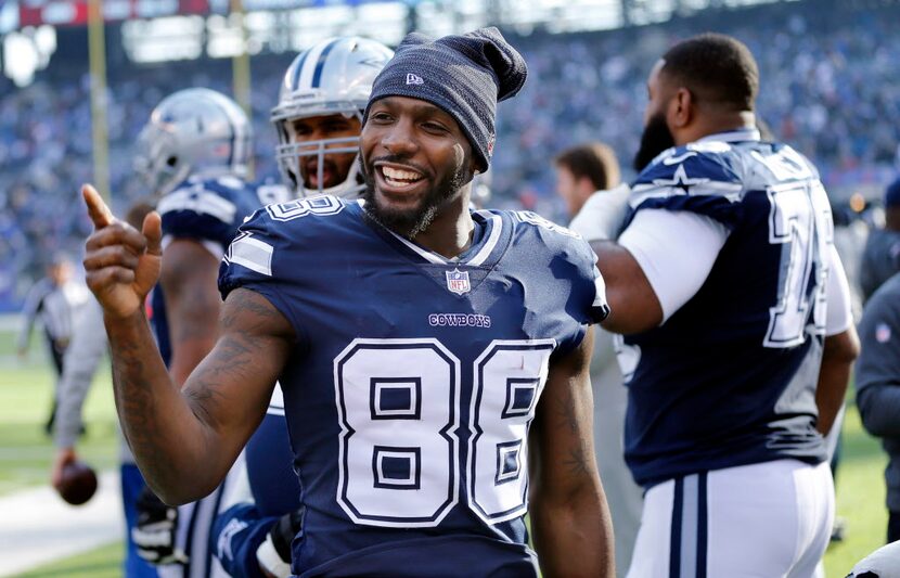 Dallas Cowboys wide receiver Dez Bryant (88) keeps it lighthearted on the sideline before...