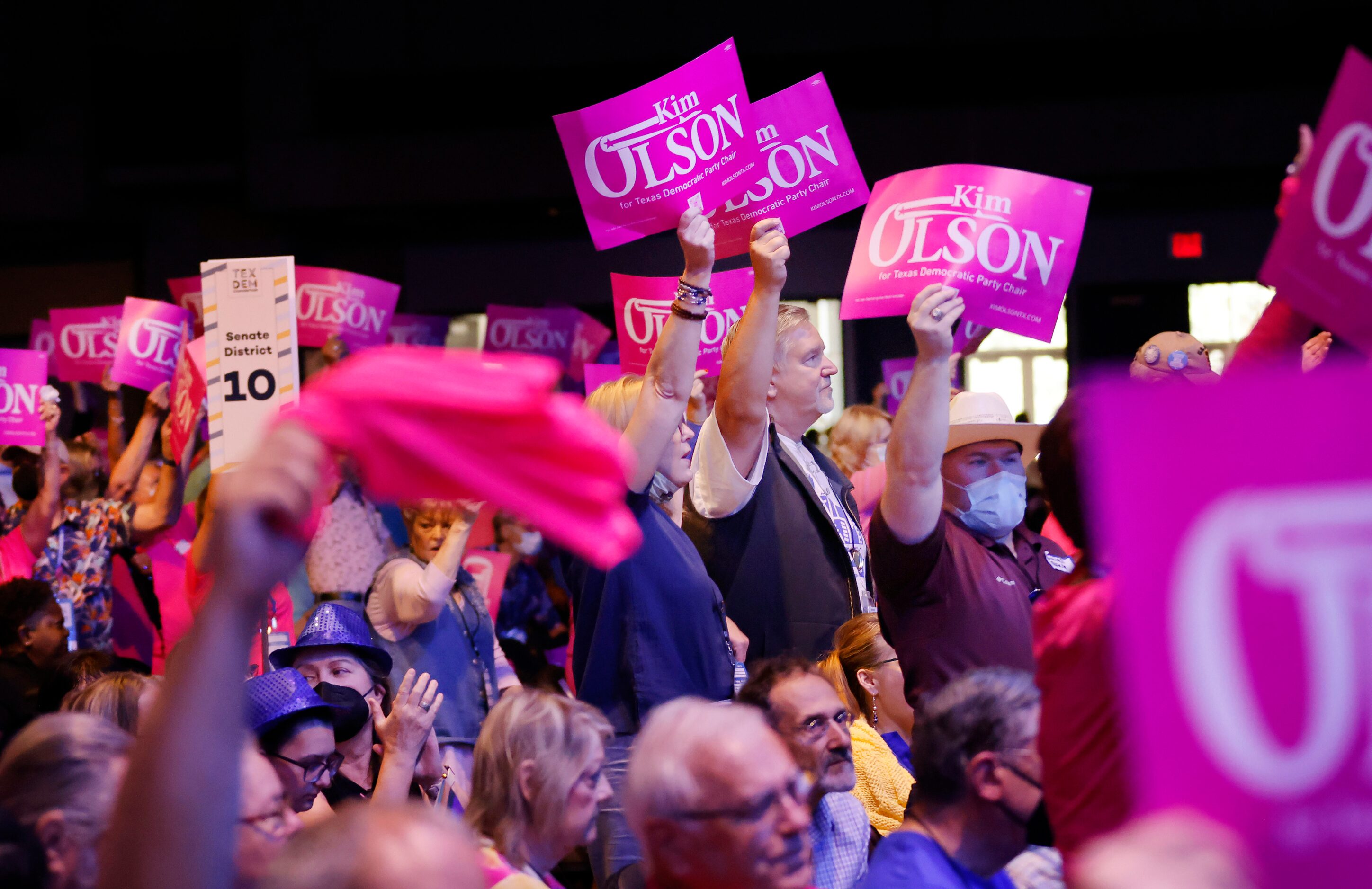 Supporters Kim Olson cheer her support to delegates before the districts vote on a Texas...