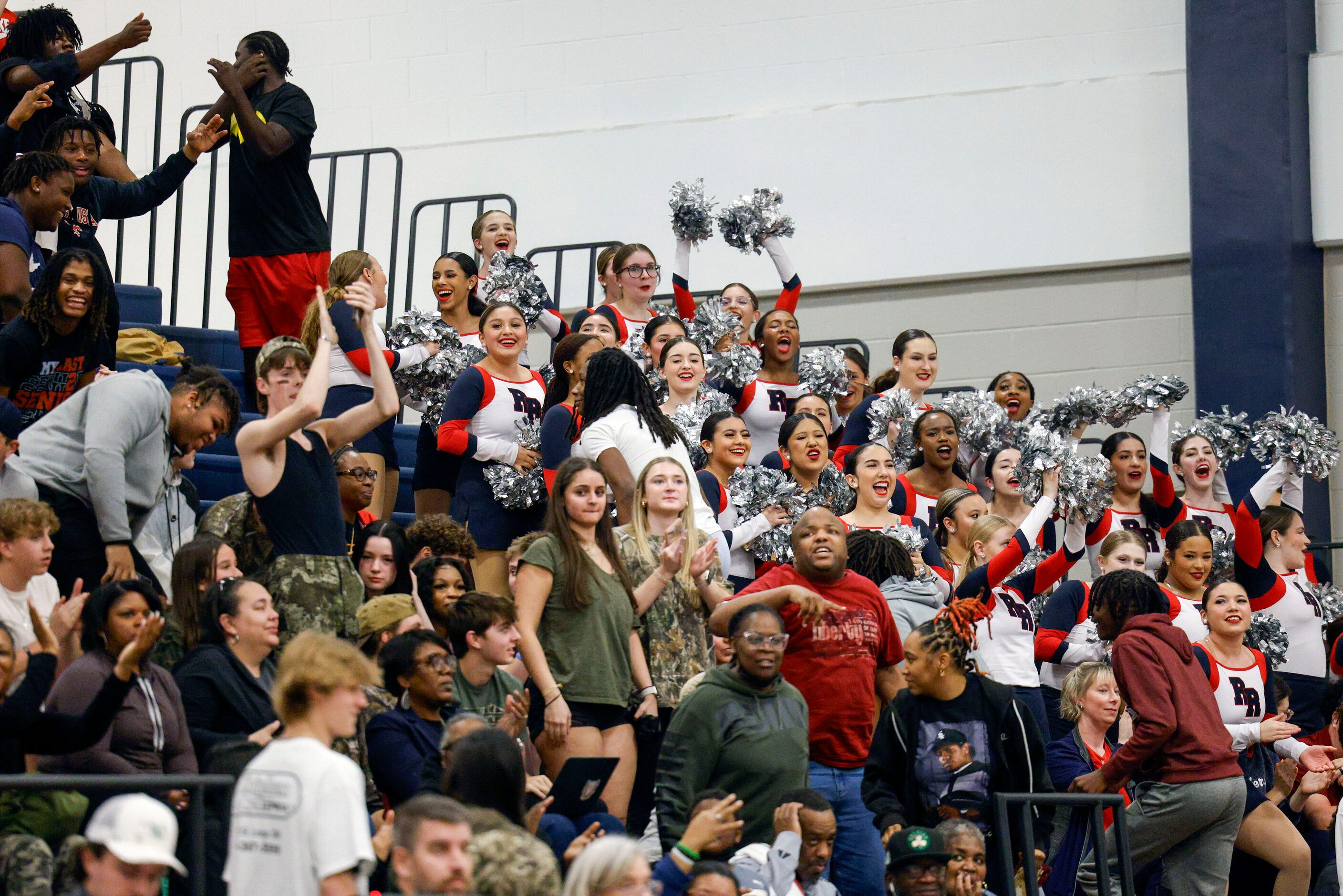 Denton Ryan students celebrate after a District 7-5A basketball game against Argyle,...