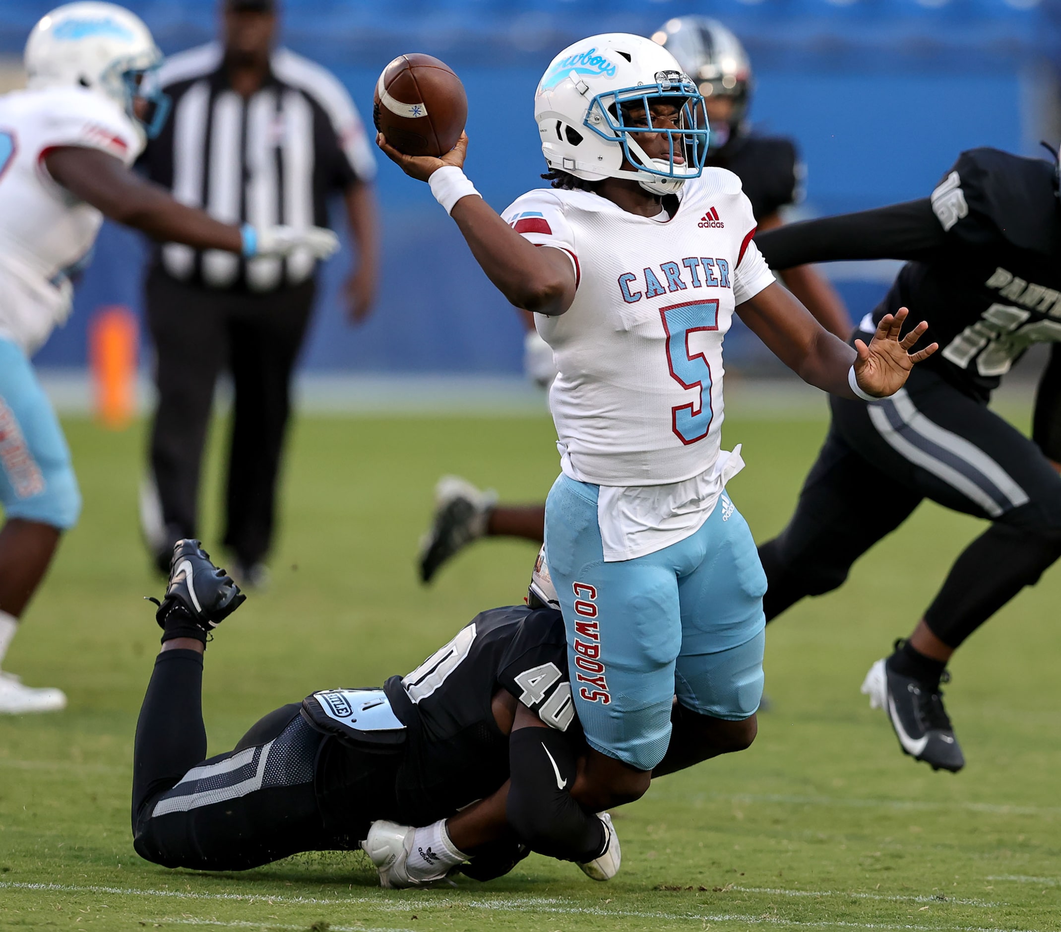 Dallas Carter quarterback Christopher Miller (5) tries to get off a pass against Frisco...